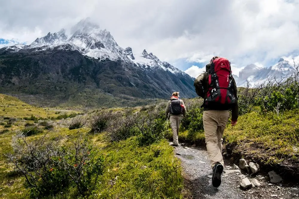 Hiker with backpack on mountain trail testing best hiking backpacks in real conditions